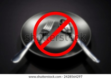 No eating or not allowed sign with blurry background, Empty plate with cutlery set blurred background, Food conceptual image  Royalty-Free Stock Photo #2428564297