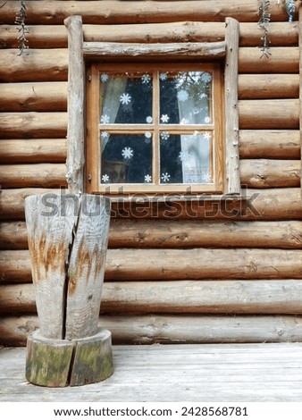 Snowflakes on the window of a wooden house