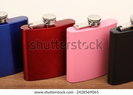 Diffirent colors stainless flask. Concept shot, top view. Custom background flask view. Flask and accessories.