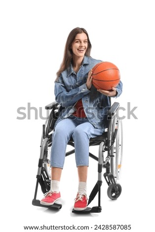 Young woman in wheelchair with ball on white background
