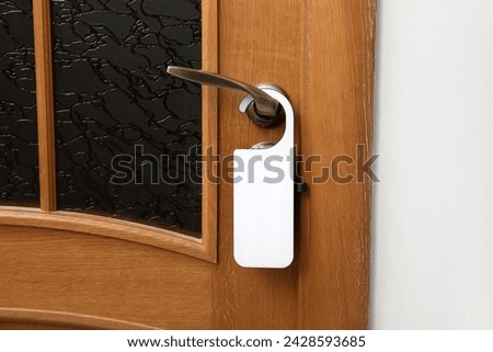 Windowed door secured with hanger in hotel room