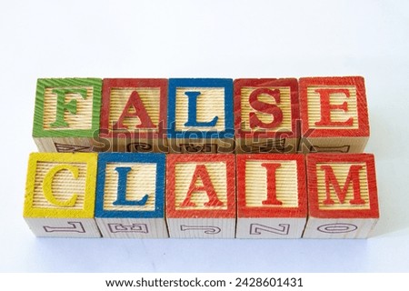 The term false claim visually displayed on a clear background with copy space in horizontal format Royalty-Free Stock Photo #2428601431