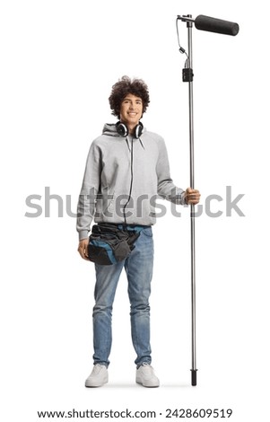 Boom operator with headphones holding a microphone and smiling at camera isolated on white background