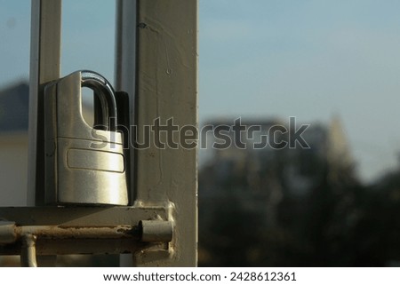 a Iron padlocks hang between the fences
