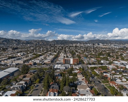Aerial view of city of Los Angeles cityscape with beautiful clouds rolling over Hollywood Hills.