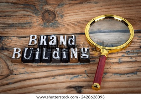 BRAND BUILDING. Alphabet letters on wood texture background.