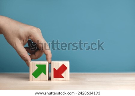 Arrows rise and fall on wooden blocks. concept of business stocks and market prices. with copy space