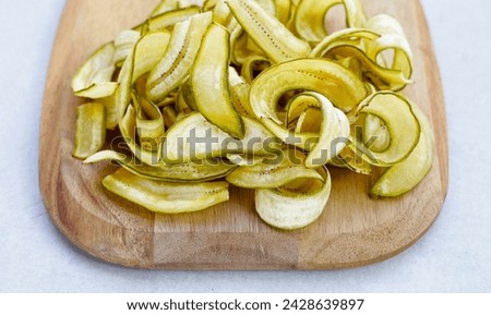 Banana chips, fried slices banana with green peel