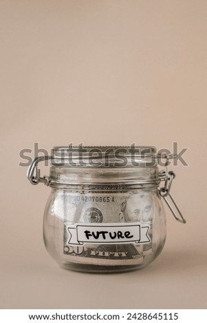 Glass jar full of American currency dollars cash banknote with text FUTURE. Preparation saving money. Moderate consumption and economy