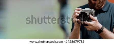 Man holding a vintage camera in his hand
