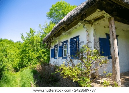 Ukrainian ancient authentic house with a thatched roof Royalty-Free Stock Photo #2428689737