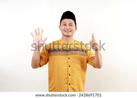Asian muslim man raising six fingers, isolated on a white background.