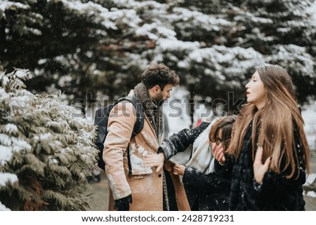 A dynamic image portraying young colleagues walking outdoors, engaging with each other on a snowy day, with snowflakes and pine trees around.