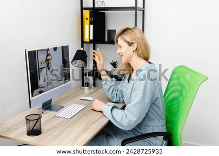 Caucasian doctor video conference call online live talk follow up remotely in medical result with woman sitting at chair at home. Online health care digital service concept Royalty-Free Stock Photo #2428725935
