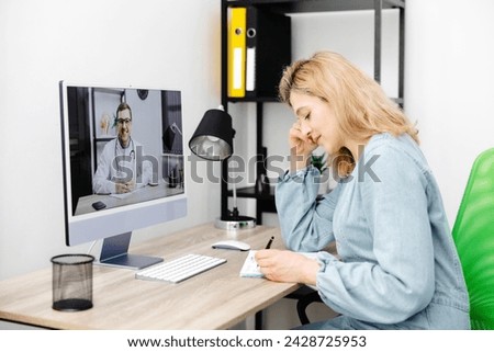 Caucasian doctor video conference call online live talk follow up remotely in medical result with woman sitting at chair at home. Online health care digital service concept Royalty-Free Stock Photo #2428725953