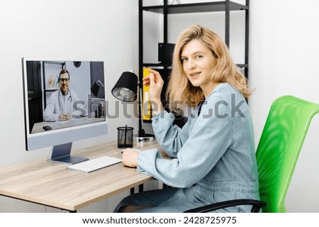 Caucasian doctor video conference call online live talk follow up remotely in medical result with woman sitting at chair at home. Online health care digital service concept Royalty-Free Stock Photo #2428725975