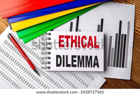 ETHICAL DILEMMA text on a notebook with pen, folder on a chart background