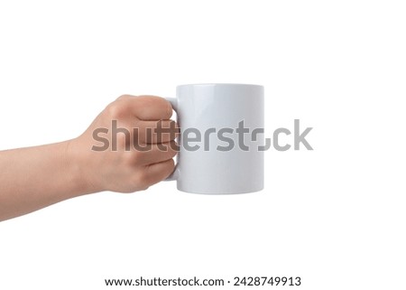 Clean white mug, held by an isolated hand, offers a perfect canvas for Print-on-Demand design promotion. Customizable and versatile Royalty-Free Stock Photo #2428749913