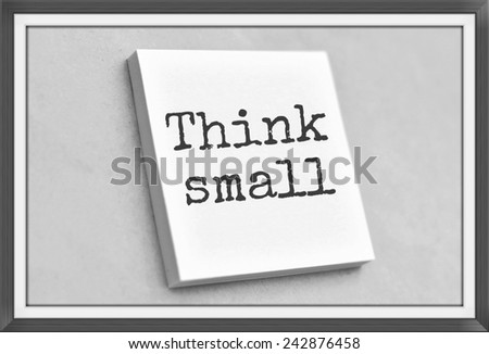 Vintage style text think small on the short note texture background