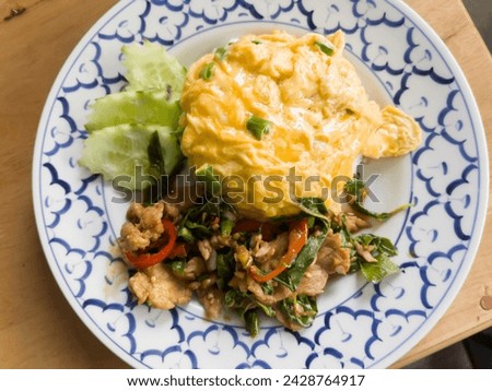Spicy Thai basil with pork and egg, stock photo