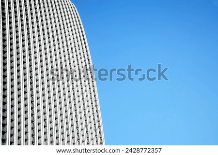 white, grey facade full of balconies. Balconies Of The Facade Of The Building. fragment of a facade of a building with balcony on blue sky background. 
