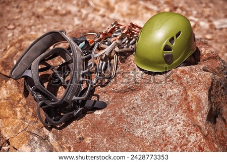 Outdoor, cliff and helmet for protection in climbing with rope on mountain for athletic fitness. Gear, equipment and extreme sports for exercise, fearless and bravery in nature for workout and thrill Royalty-Free Stock Photo #2428773353
