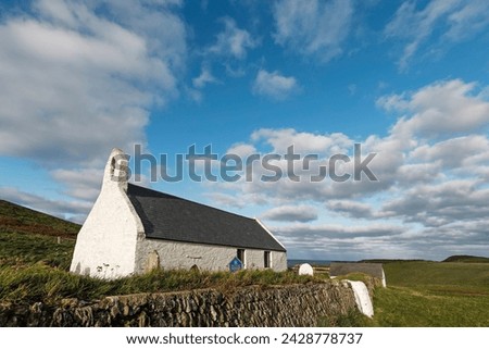 The 13th century church of the holy cross, a grade 1 listed parish church near popular mwnt beach, mwnt, ceredigion, wales, united kingdom, europe Royalty-Free Stock Photo #2428778737