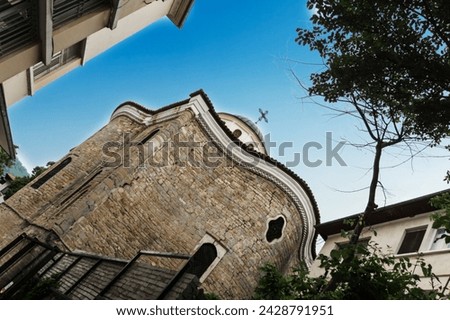 Old brick building. Church of Saints Constantine and Helena from a narrow street in the medieval town of Veliko Tarnovo in Bulgaria. The concept of tourism and travel. Dutch angle Royalty-Free Stock Photo #2428791951