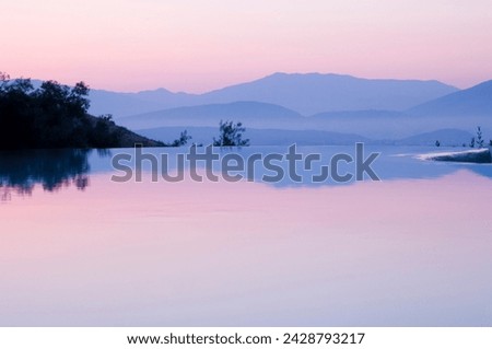 An infinity pool at sunrise and mountains of albania taken from ayios stefanos, corfu, ionian islands, greek islands, greece, europe Royalty-Free Stock Photo #2428793217