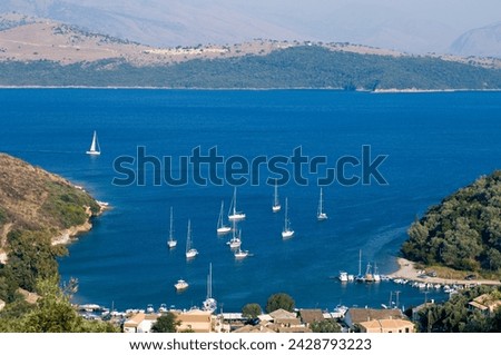View over the harbour of ayios stefanos, across the ionian sea to the mountains of albania, corfu, ionian islands, greek islands, greece, europe Royalty-Free Stock Photo #2428793223