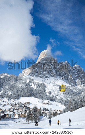A view toward the town of corvara and gondola at the alta badia ski resort with sassongher mountain behind, dolomites, south tyrol, italy, europe