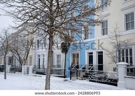 Pastel coloured houses on a snowy day in elgin crescent in the notting hill area of london, england, united kingdom, europe