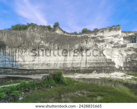 Panoramic landscape of Bukit Jaddih or Jaddih Hills, Bangkalan, Madura Island with white limestone cliffs and blue sky