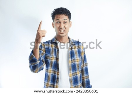Wow, attention to advertising! Portrait of happy Asian Student man pointing to side copy space isolated on white background. Education in high school university college concept