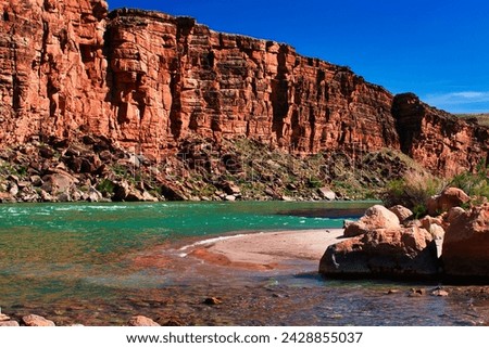 Sunlight dances on the surface of the Colorado River as seen from Cathedral Wash Trail, a popular hiking route renowned for its stunning vistas and rugged beauty. Royalty-Free Stock Photo #2428855037