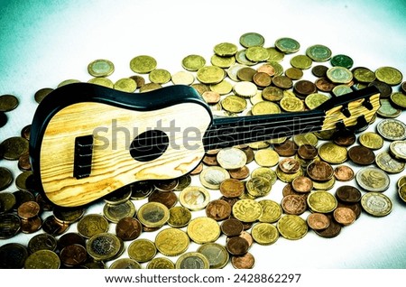 Picture of a Business Money Concept Idea Coins and Guitar