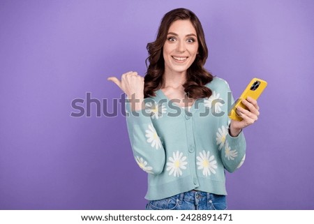 Photo of brunette girl in blue shirt directing finger innovation feature upgrade new apple iphone 15 isolated on violet color background