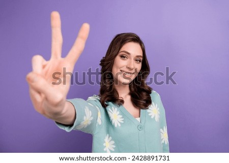 Photo of shiny adorable lady dressed flower print cardigan showing you v-sign isolated violet color background