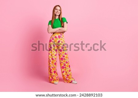 Full length photo of satisfied lovely woman dressed green t-shirt retro trousers keep hands crossed isolated on pink color background
