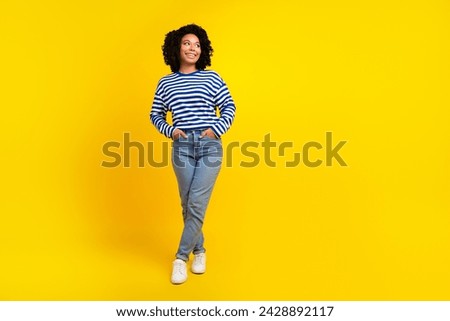 Full size photo of cheerful woman dressed striped sweatshirt palms in pockets look at sale empty space isolated on yellow color background