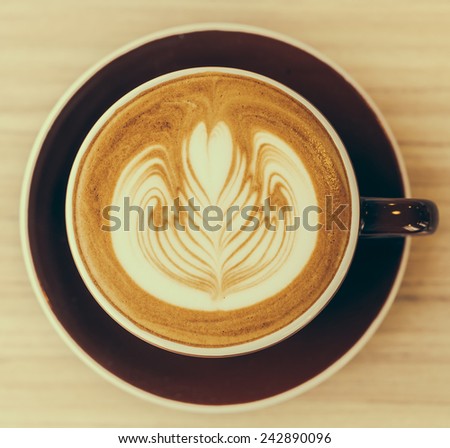 Latte coffee cup on wooden table - vintage effect style pictures