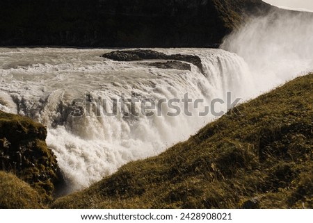 Traveling and exploring Iceland landscapes and famous places. Autumn tourism by Atlantic Ocean and mountains. Outdoor views on beautiful cliffs and travel destinations. Gullfoss waterfall.