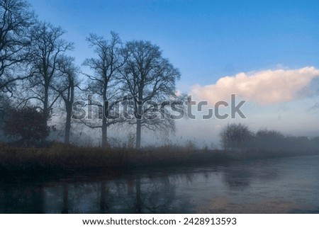 Misty and frozen canal near the village Heeten Royalty-Free Stock Photo #2428913593