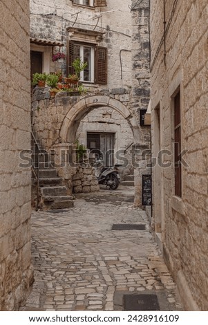 Narrow street in historic district of Trogir, Croatia