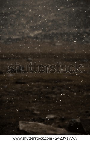 A photo of a snowy foreground with a mountainous background.