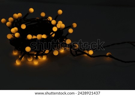Beautiful glowing Christmas lights on dark background