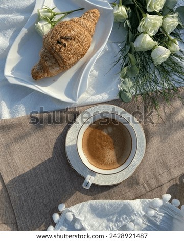 Coffee cup background with croissant and rose