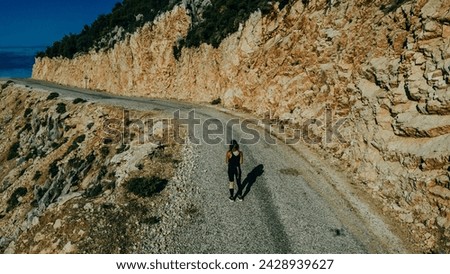 girl runs along the road in the mountains. High quality photo