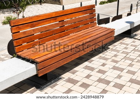 Wooden and concrete bench in the city park