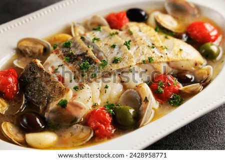 Aqua pazza made with cod, clams and garlic
